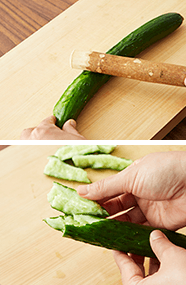 キュウリは塩を振って板ずりをし、すりこぎで叩いてひびを入れる。ひび割れたところから食べやすい大きさにほぐす。